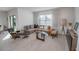 Bright living room with a large sectional, modern furniture, and sliding glass doors at 860 Killarney Ln, Auburndale, FL 33823