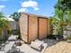 Wooden backyard shed with two lounge chairs sitting on the patio at 901 Spicewood Dr, Lakeland, FL 33801