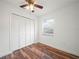 Bedroom features hardwood floors, a modern ceiling fan, and a window at 901 Spicewood Dr, Lakeland, FL 33801