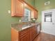 Kitchen featuring stainless steel appliances and warm-toned cabinets at 901 Spicewood Dr, Lakeland, FL 33801