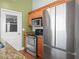 Well-equipped kitchen with stainless steel appliances, granite countertops, and wood cabinets at 901 Spicewood Dr, Lakeland, FL 33801