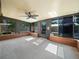 Spacious sunroom featuring gray floors and multiple large windows at 901 Spicewood Dr, Lakeland, FL 33801