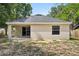Rear exterior of the home showcasing the patio, sliding glass doors, and backyard at 950 W 2Nd St, Lakeland, FL 33805