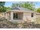 Rear exterior of the home showcasing the patio, sliding glass doors, and backyard at 950 W 2Nd St, Lakeland, FL 33805