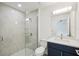 Updated bathroom featuring a glass enclosed shower, white marble tile and vanity with quartz countertop at 950 W 2Nd St, Lakeland, FL 33805