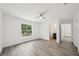 Bright bedroom featuring wood-look flooring, ceiling fan, and ample natural light from the window at 950 W 2Nd St, Lakeland, FL 33805