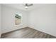 Clean bright bedroom with wood-look floors and window at 950 W 2Nd St, Lakeland, FL 33805