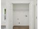 Walk-in closet with bifold doors and wire shelving in a room with light grey luxury vinyl floors at 950 W 2Nd St, Lakeland, FL 33805