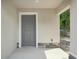 Covered entryway featuring a modern gray door and stone veneer accents at 950 W 2Nd St, Lakeland, FL 33805