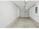 Spacious garage with a concrete floor, overhead door, and electrical panel at 950 W 2Nd St, Lakeland, FL 33805