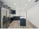 Bright modern kitchen features stainless steel appliances, shaker cabinets, and an eat-in island at 950 W 2Nd St, Lakeland, FL 33805