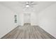 Bright living room featuring new flooring, modern ceiling fan, and natural light at 950 W 2Nd St, Lakeland, FL 33805