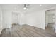 Bright living room with new gray flooring, ceiling fan, and fresh white paint at 950 W 2Nd St, Lakeland, FL 33805