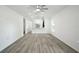 Spacious living area with new floors, modern ceiling fan, and kitchen view at 950 W 2Nd St, Lakeland, FL 33805