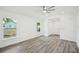 Clean, well-lit living room featuring gray flooring, white walls, and ceiling fan at 950 W 2Nd St, Lakeland, FL 33805
