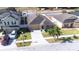 Aerial view showcases the property, its well-kept lawn, landscaping, and a two car driveway at 983 Revere Ave, Haines City, FL 33844