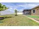 Well-maintained backyard with a manicured lawn and a charming screened porch perfect for outdoor relaxation at 983 Revere Ave, Haines City, FL 33844