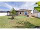 Lush backyard showcases a well-maintained lawn and the home's exterior, creating a private outdoor space at 983 Revere Ave, Haines City, FL 33844