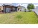 Expansive backyard with lush green grass, complemented by a pristine vinyl fence for added privacy at 983 Revere Ave, Haines City, FL 33844