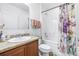 Bright bathroom featuring a shower with patterned curtain, vanity, and neutral color scheme at 983 Revere Ave, Haines City, FL 33844