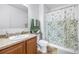Clean bathroom features a shower with patterned curtain, vanity, and neutral color scheme at 983 Revere Ave, Haines City, FL 33844