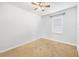 A bedroom with neutral walls, carpet, and a window for natural light with ceiling fan at 983 Revere Ave, Haines City, FL 33844