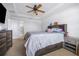 Spacious bedroom with a ceiling fan, a king bed, and an adjacent bathroom at 983 Revere Ave, Haines City, FL 33844