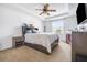Bright bedroom featuring a ceiling fan, a large bed, and a window offering natural light at 983 Revere Ave, Haines City, FL 33844