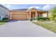 Charming single-story home with a two-car garage, well-maintained lawn, and inviting curb appeal at 983 Revere Ave, Haines City, FL 33844