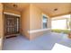 Inviting front porch with a decorative door and sidelight, perfect for enjoying the outdoors at 983 Revere Ave, Haines City, FL 33844