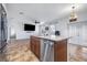 Modern kitchen island with granite countertops and stainless steel appliances provides ample workspace and storage at 983 Revere Ave, Haines City, FL 33844