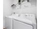 Laundry room featuring a white washer and dryer set with a shelf at 983 Revere Ave, Haines City, FL 33844
