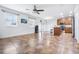 Open-concept living room with abundant natural light and tile flooring flowing into the kitchen at 983 Revere Ave, Haines City, FL 33844