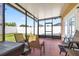 Screened in porch showcasing outdoor seating, with views of the backyard and white vinyl privacy fence at 983 Revere Ave, Haines City, FL 33844