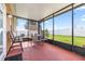 Enclosed porch features ample seating and offers a relaxing outdoor space to enjoy the backyard at 983 Revere Ave, Haines City, FL 33844