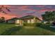 Exterior view of home with screened lanai and well-maintained lawn at 1036 Stoney Creek Dr, Lakeland, FL 33811