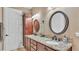 Beautiful bathroom features granite counters, dual sinks, stylish mirrors, and attractive wood cabinets at 1036 Stoney Creek Dr, Lakeland, FL 33811