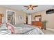 Comfortable bedroom featuring dresser, mirror, ceiling fan and natural light from window with blinds at 1036 Stoney Creek Dr, Lakeland, FL 33811