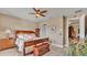 Comfortable bedroom features a ceiling fan, a window, and a wooden accent chest at the foot of the bed at 1036 Stoney Creek Dr, Lakeland, FL 33811