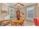 Cozy dining area with plantation shutters, wood table and a traditional grandfather clock at 1036 Stoney Creek Dr, Lakeland, FL 33811