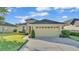 Charming single-story home featuring a manicured lawn, neutral exterior, and a two-car garage at 1036 Stoney Creek Dr, Lakeland, FL 33811