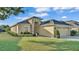 Inviting single-story home with lush green lawn and stone accents around the front entryway at 1036 Stoney Creek Dr, Lakeland, FL 33811
