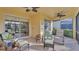 Spacious screened lanai with comfortable seating and fan, perfect for relaxing outdoors at 1036 Stoney Creek Dr, Lakeland, FL 33811