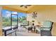 Screened lanai featuring comfortable seating and a ceiling fan, perfect for relaxing outdoors at 1036 Stoney Creek Dr, Lakeland, FL 33811