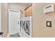 Functional laundry room with modern washer and dryer, cabinet storage, and convenient access at 1036 Stoney Creek Dr, Lakeland, FL 33811