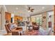 Open-concept living area showcasing comfortable leather seating, a kitchen, and sliding glass doors to lanai at 1036 Stoney Creek Dr, Lakeland, FL 33811