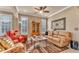 Inviting living room with comfortable seating, ceiling fan, and stylish decor for relaxation and entertainment at 1036 Stoney Creek Dr, Lakeland, FL 33811