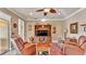 Inviting living room featuring comfortable leather seating, a ceiling fan, and a built-in entertainment center at 1036 Stoney Creek Dr, Lakeland, FL 33811