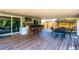 Outdoor deck with a custom-built bar, ample seating, and views of the landscaped backyard, ideal for gatherings at 1061 Lowry Ave, Lakeland, FL 33801
