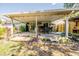 Outdoor deck with a custom bar, seating area, and well-maintained lawn, great for entertaining and relaxing outdoors at 1061 Lowry Ave, Lakeland, FL 33801